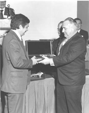 J.D. Jones receiving the Auto Mag from Harry Sanford